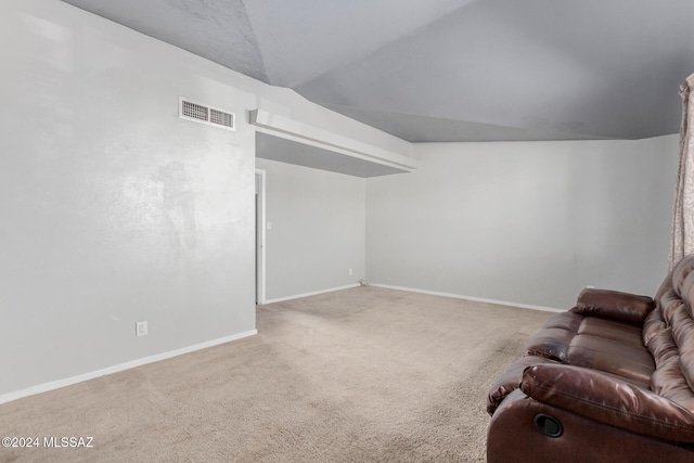 living room featuring lofted ceiling and carpet flooring