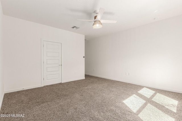 unfurnished room with a ceiling fan, baseboards, visible vents, and carpet flooring