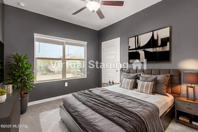 carpeted bedroom with ceiling fan and baseboards