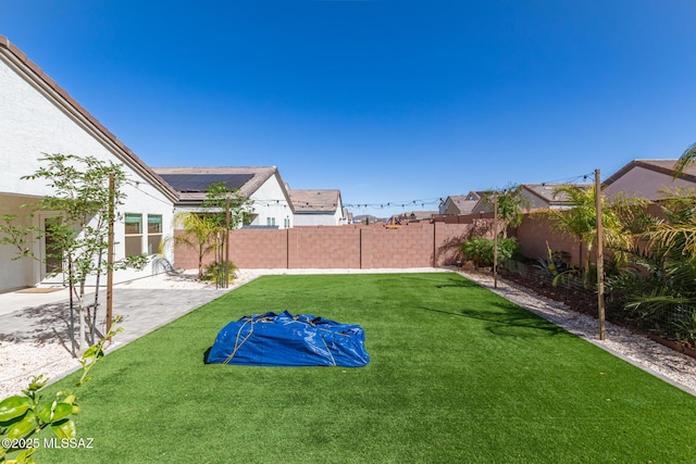 view of yard featuring a patio area and a fenced backyard