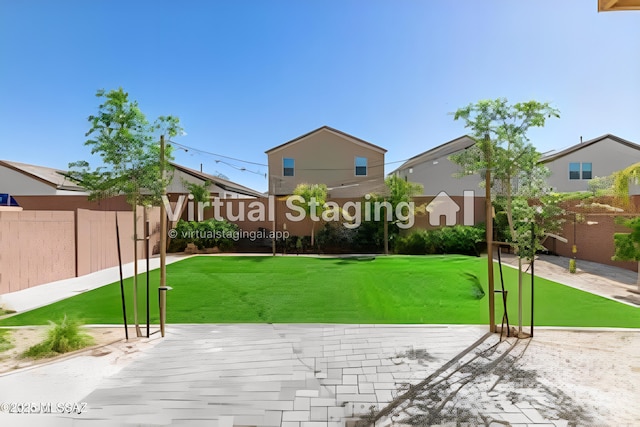 exterior space with a lawn and fence