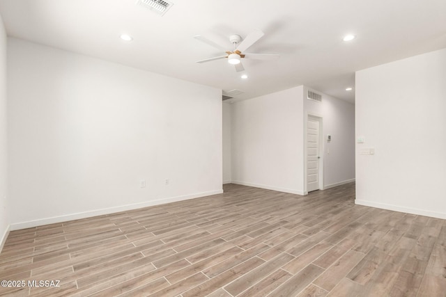 spare room with light wood-style floors, visible vents, and recessed lighting