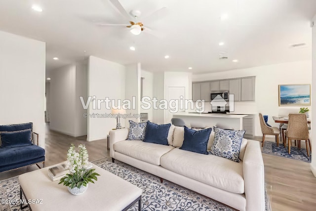 living area featuring light wood-type flooring and recessed lighting