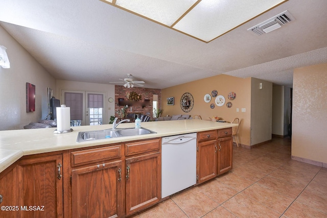 kitchen with dishwasher, sink, ceiling fan, kitchen peninsula, and a textured ceiling