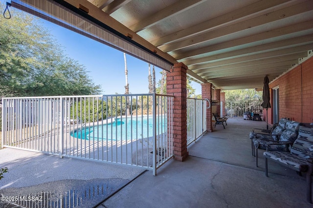 view of patio with a fenced in pool