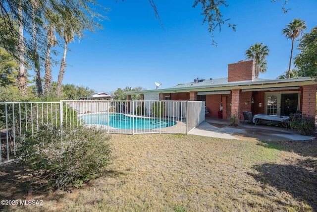 view of swimming pool with a yard and a patio area