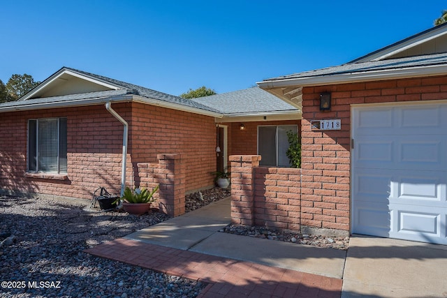 view of exterior entry featuring a garage