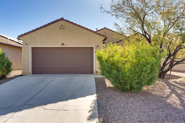 view of front of house featuring a garage and an outdoor structure