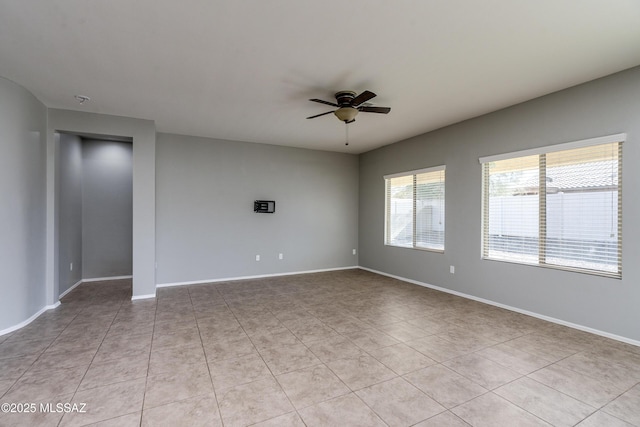 spare room featuring ceiling fan and light tile patterned floors