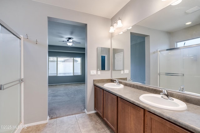 bathroom featuring ceiling fan, vanity, an enclosed shower, and tile patterned flooring