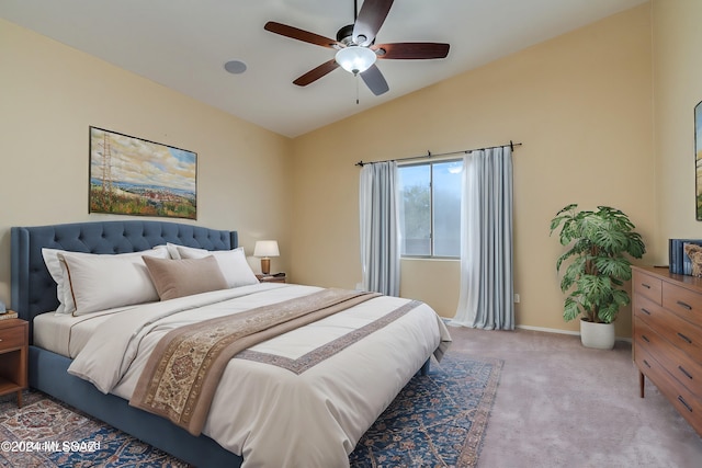 carpeted bedroom with lofted ceiling and ceiling fan