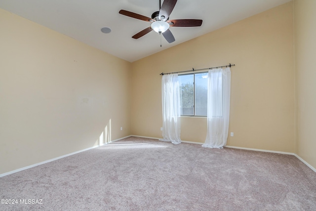 carpeted spare room with vaulted ceiling and ceiling fan