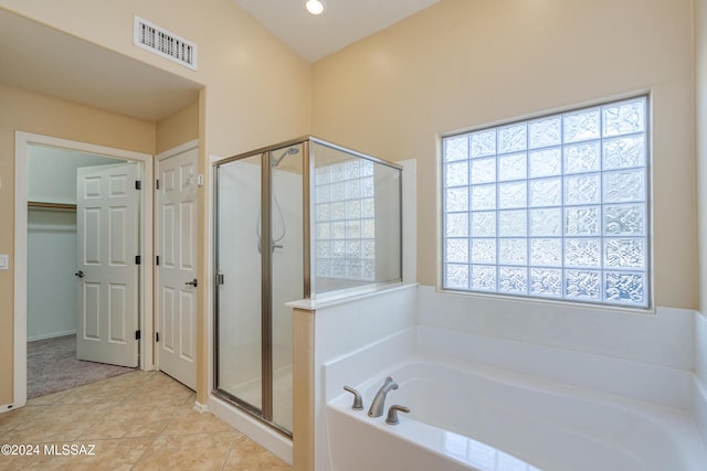 bathroom featuring tile patterned floors and separate shower and tub