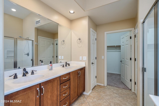 bathroom with vanity, tile patterned floors, and walk in shower