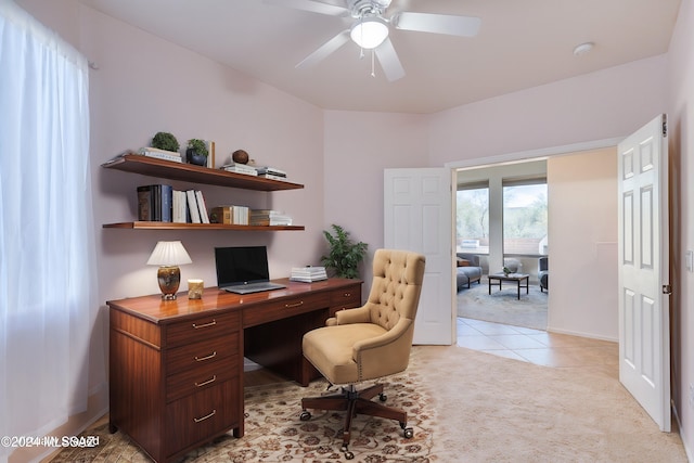 home office with light carpet and ceiling fan