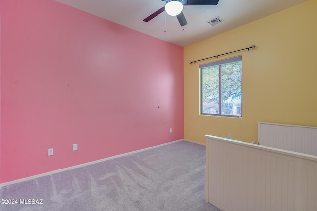 unfurnished room featuring ceiling fan and light carpet