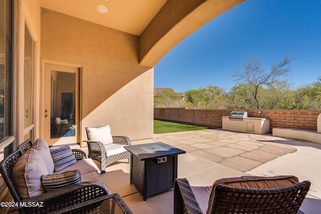 view of patio featuring an outdoor living space and an outdoor kitchen