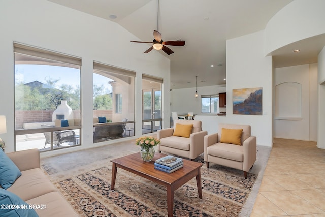 tiled living room featuring high vaulted ceiling and ceiling fan