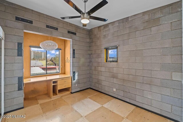 1125 N 13th Ave, Tucson, AZ 85705 - empty room with concrete block wall and a ceiling fan