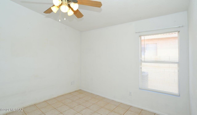 empty room featuring light tile patterned floors and ceiling fan