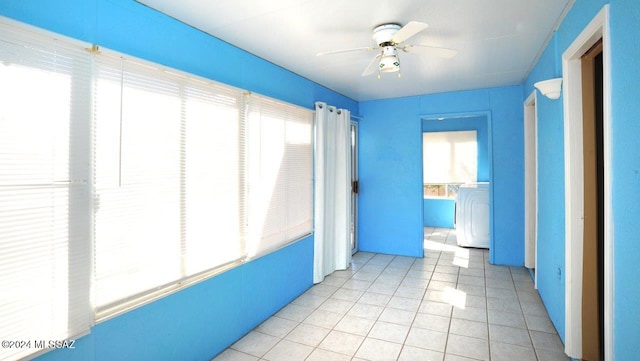 interior space featuring light tile patterned floors and washer / dryer