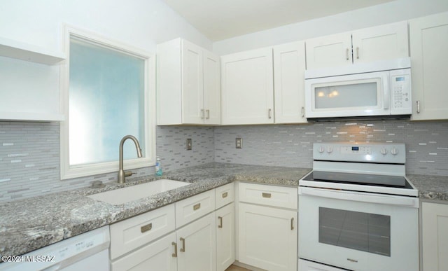 kitchen featuring sink, white appliances, light stone countertops, decorative backsplash, and white cabinets