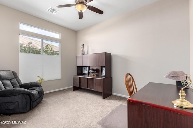 office space with light colored carpet and ceiling fan