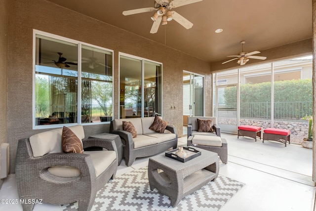 sunroom / solarium featuring ceiling fan