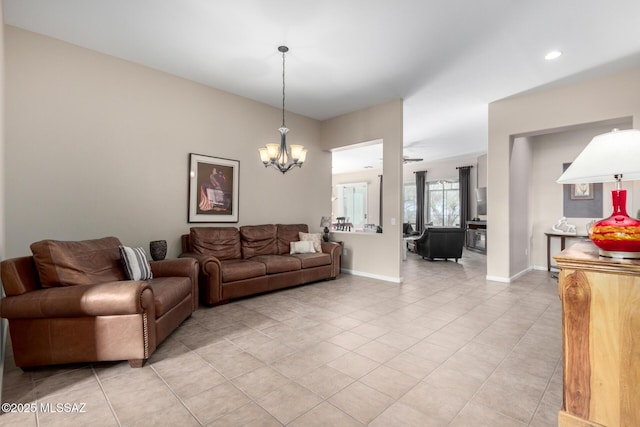 living room with light tile patterned flooring and a notable chandelier