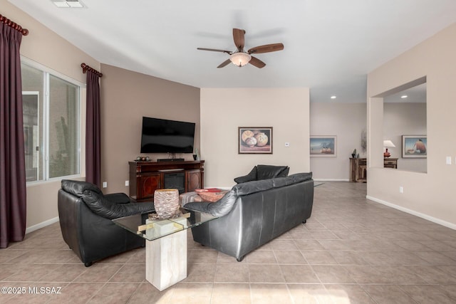 tiled living room with ceiling fan