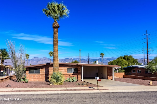 single story home featuring a carport and a mountain view