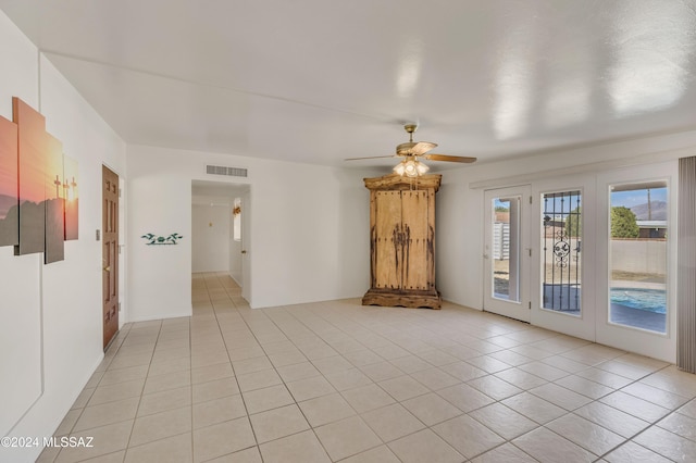 tiled empty room with ceiling fan