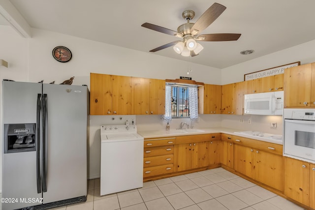 kitchen featuring light tile patterned floors, white appliances, sink, ceiling fan, and washer / dryer