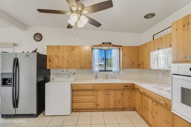 kitchen featuring washer / clothes dryer, sink, light tile patterned floors, and white appliances