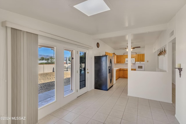 kitchen with white appliances, ceiling fan, and light tile patterned flooring