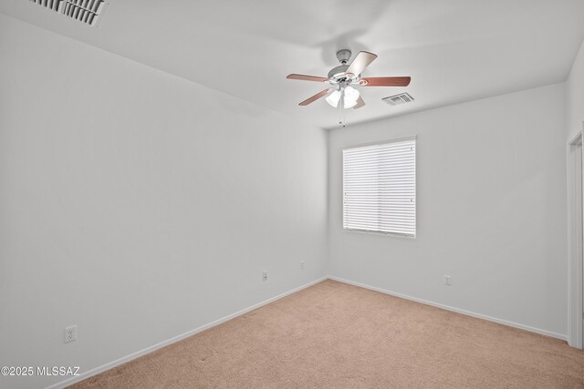 carpeted empty room featuring ceiling fan