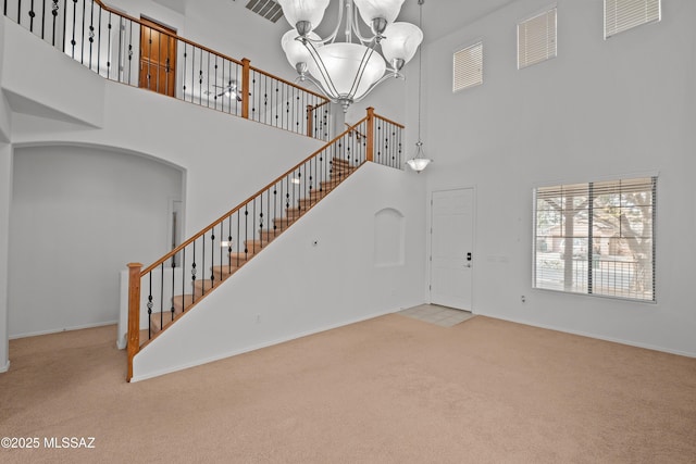 interior space featuring a chandelier and a high ceiling