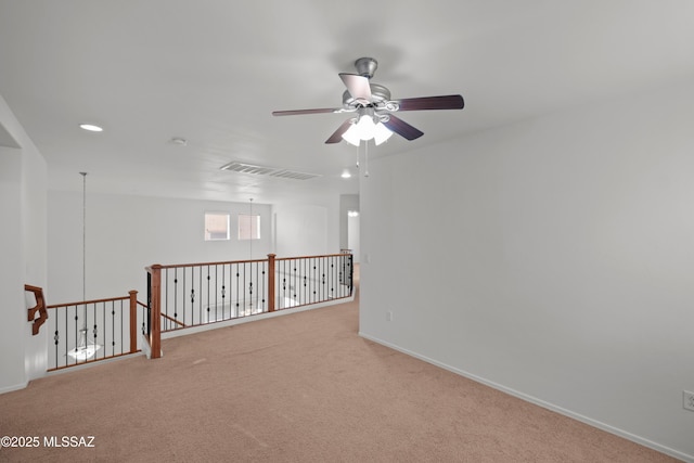 carpeted empty room featuring ceiling fan
