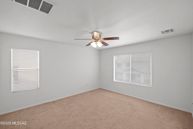 unfurnished room with ceiling fan and light carpet