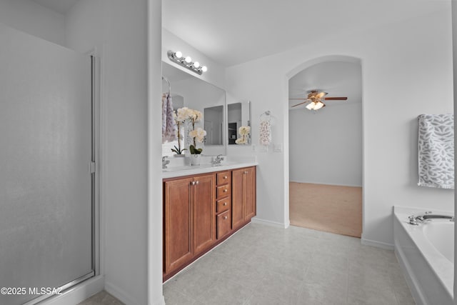 bathroom with vanity, plus walk in shower, and ceiling fan