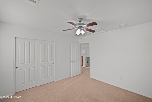 unfurnished bedroom with light carpet, a closet, and ceiling fan