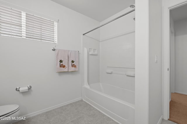bathroom with tile patterned flooring, toilet, and washtub / shower combination