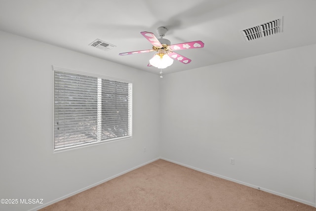 carpeted spare room with ceiling fan