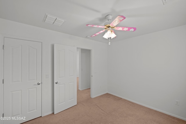 unfurnished bedroom featuring light carpet and ceiling fan