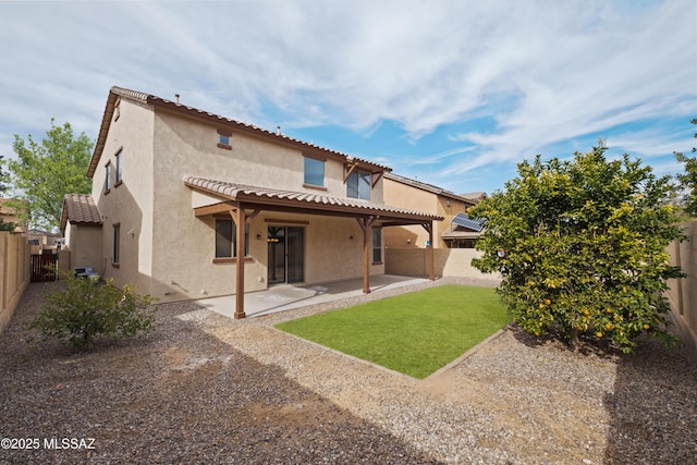 rear view of property featuring a yard and a patio