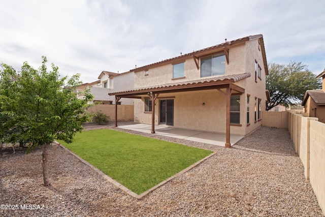 rear view of property with a yard and a patio area