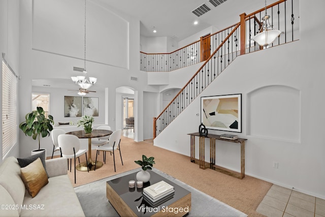 living room with ceiling fan, light colored carpet, and plenty of natural light