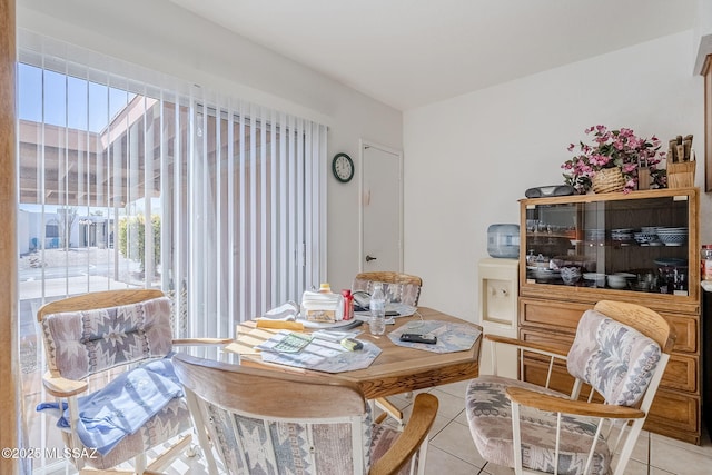 dining area featuring light tile patterned floors and a skylight