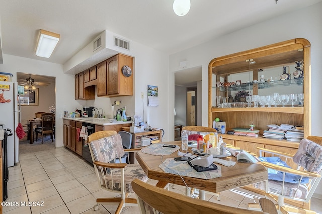 dining space featuring light tile patterned floors and ceiling fan