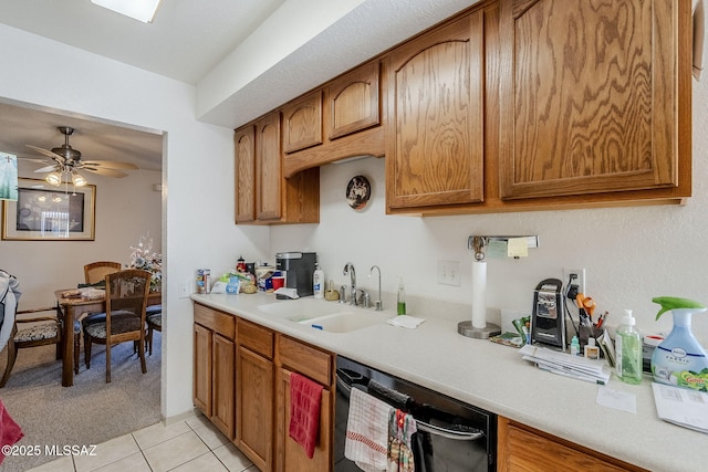 kitchen with sink, light tile patterned floors, black dishwasher, and ceiling fan